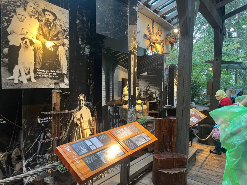 A group checks out some historical photos at the storey centre at Capilano Suspension Bridge.