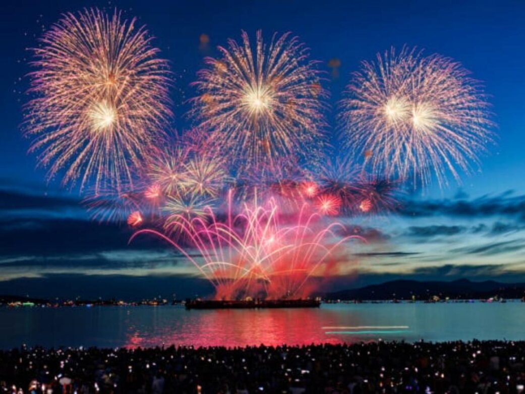 a mass of people gathered watching fireworks at night one of vancouver fireworks events