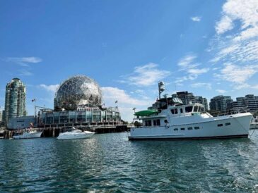 view of the science world dome and the yacht from false creek on a fair day