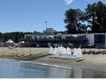 showcasing the jericho beach sailing center with its kayaks and sailing boats by the beach shore
