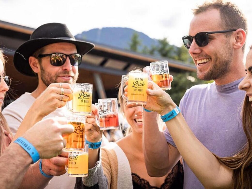a group of friends enjoying full glasses of beer during the whistler village beer festival