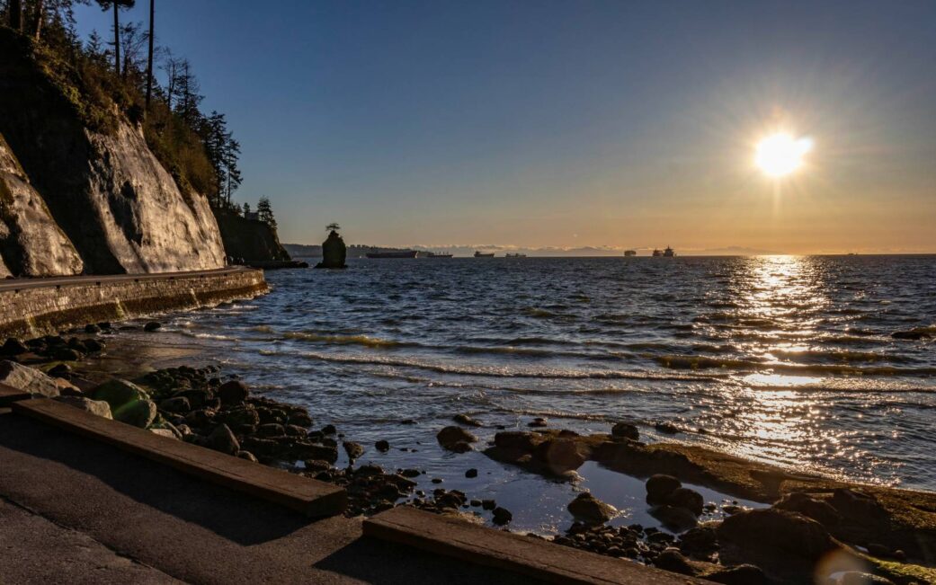 The view of the Salish Sea from Zeus Beach and Siwash Rock from the Seawall in Vancouver, BC.